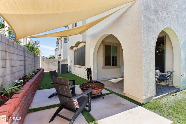 6641 N Desert Shadow Ln, Phoenix, AZ 85014 - view of patio / terrace featuring an outdoor fire pit, a fenced backyard, and central air condition unit