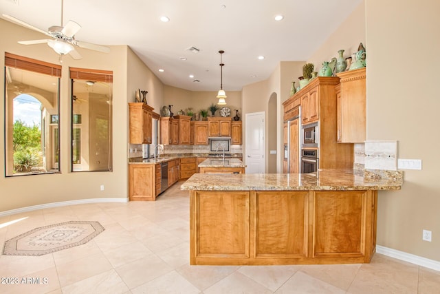 kitchen with light tile patterned floors, kitchen peninsula, appliances with stainless steel finishes, and decorative backsplash