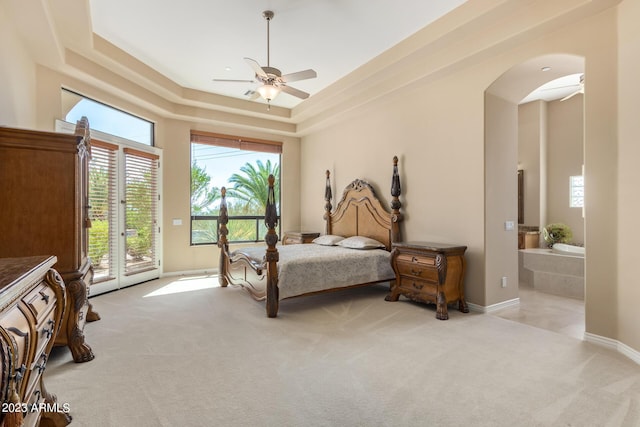 carpeted bedroom featuring a tray ceiling, ceiling fan, and access to outside