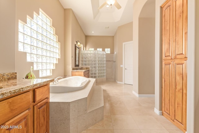 bathroom featuring vanity, ceiling fan, shower with separate bathtub, and tile patterned flooring