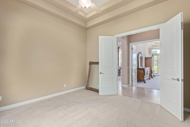 empty room with light colored carpet and ceiling fan