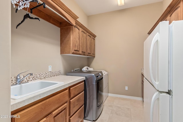 laundry area with sink, cabinets, and washer and dryer