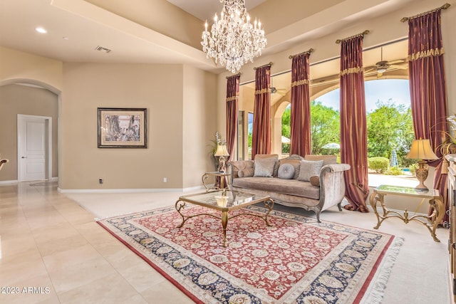 living room featuring ceiling fan with notable chandelier