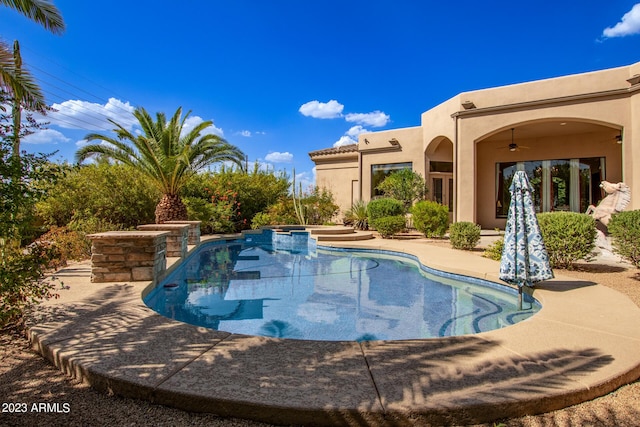 view of pool featuring ceiling fan, a patio area, and an in ground hot tub