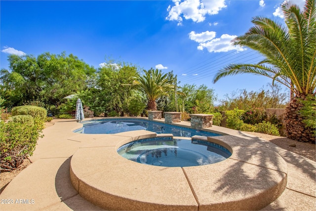 view of pool with an in ground hot tub and a patio