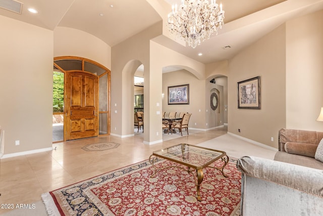 living room with a towering ceiling and an inviting chandelier