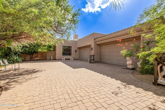 pueblo-style house featuring a garage