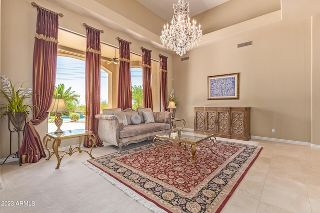 living room featuring a towering ceiling and a chandelier