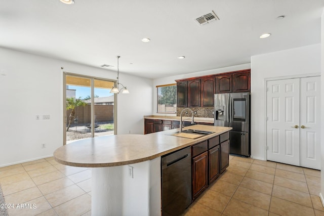 kitchen featuring a center island with sink, a wealth of natural light, decorative light fixtures, and appliances with stainless steel finishes