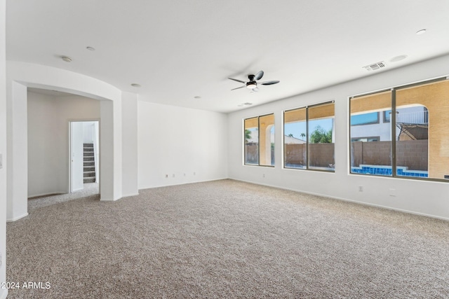 unfurnished room featuring ceiling fan and carpet