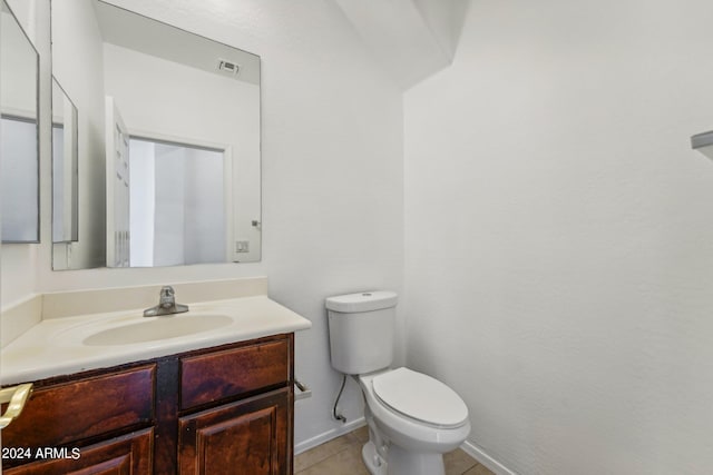 bathroom featuring tile patterned floors, vanity, and toilet