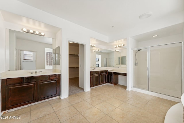 bathroom featuring vanity, a shower with door, and tile patterned floors