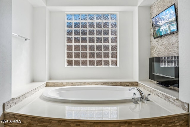 bathroom featuring a relaxing tiled tub