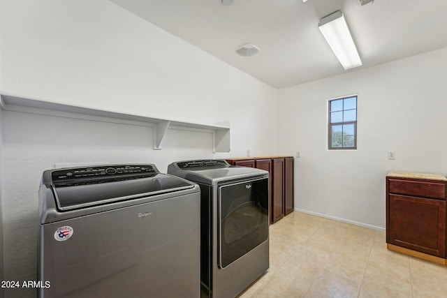 washroom with cabinets and separate washer and dryer