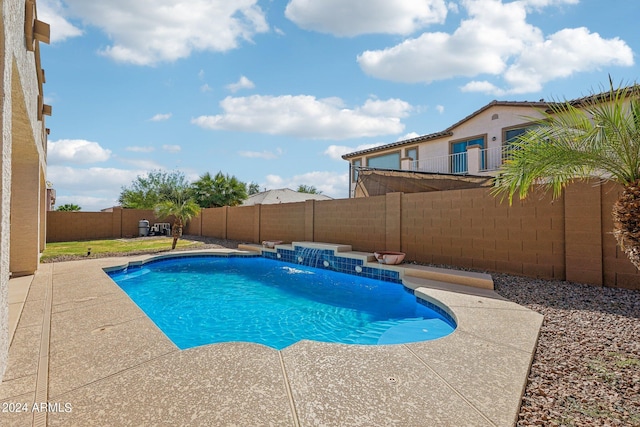 view of pool with a patio and pool water feature