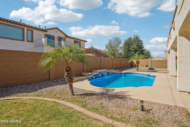 view of swimming pool featuring pool water feature and a patio area