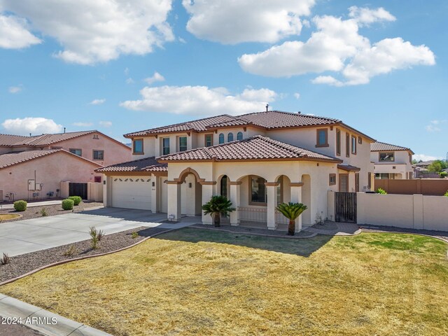 mediterranean / spanish-style home with a front lawn