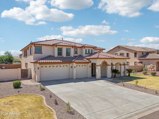 mediterranean / spanish home with a front yard and a garage