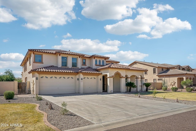 mediterranean / spanish-style house with a front lawn and a garage