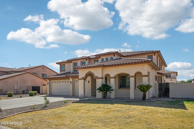 mediterranean / spanish-style home featuring a front yard and a garage