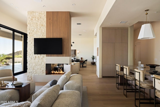 12887 N 135th St, Scottsdale, AZ 85259 - living room featuring light wood-style flooring, a fireplace, and recessed lighting