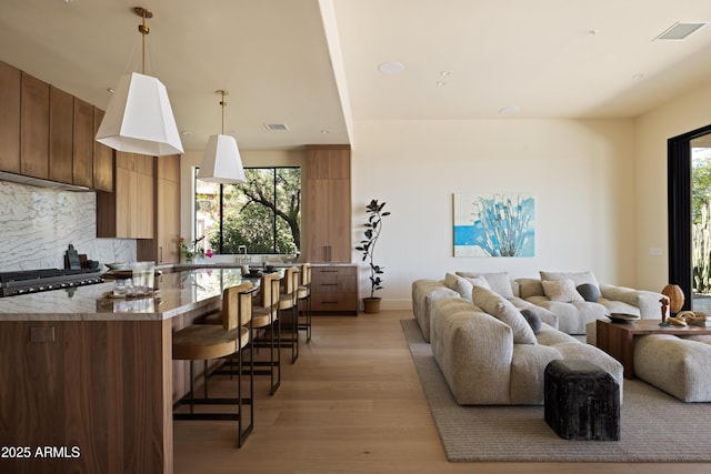 12887 N 135th St, Scottsdale, AZ 85259 - living room featuring light wood-type flooring and recessed lighting
