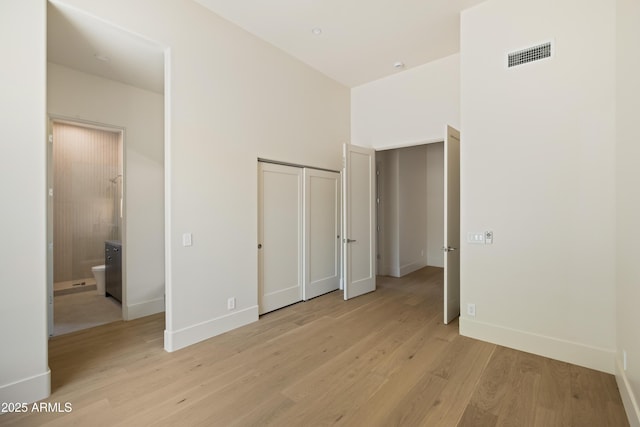 12887 N 135th St, Scottsdale, AZ 85259 - unfurnished bedroom with light wood-style floors, a closet, and connected bathroom