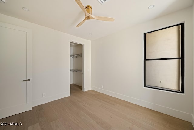 12887 N 135th St, Scottsdale, AZ 85259 - unfurnished bedroom featuring light wood-style floors, recessed lighting, a ceiling fan, and a spacious closet