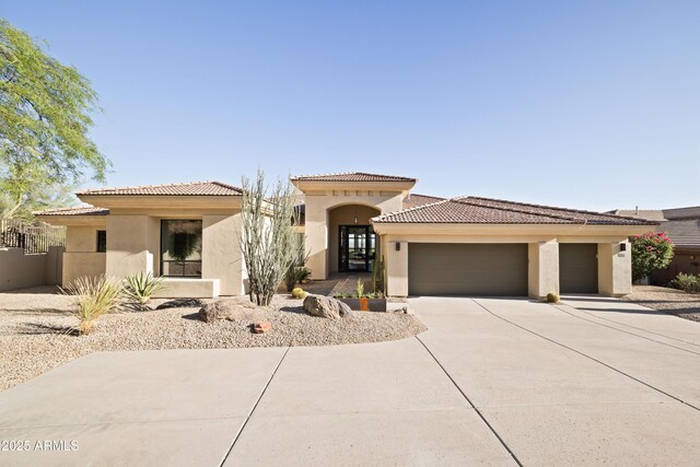 12887 N 135th St, Scottsdale, AZ 85259 - mediterranean / spanish home featuring stucco siding, an attached garage, driveway, and a tiled roof