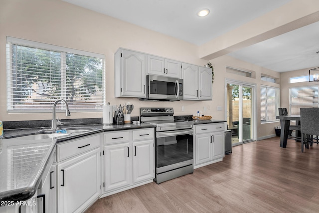 1574 E Scott Ave, Gilbert, AZ 85234 - kitchen with appliances with stainless steel finishes, light wood-style floors, white cabinets, recessed lighting, and beam ceiling