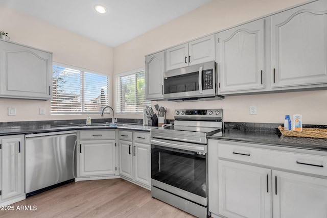1574 E Scott Ave, Gilbert, AZ 85234 - kitchen featuring appliances with stainless steel finishes, dark countertops, recessed lighting, light wood-type flooring, and white cabinetry