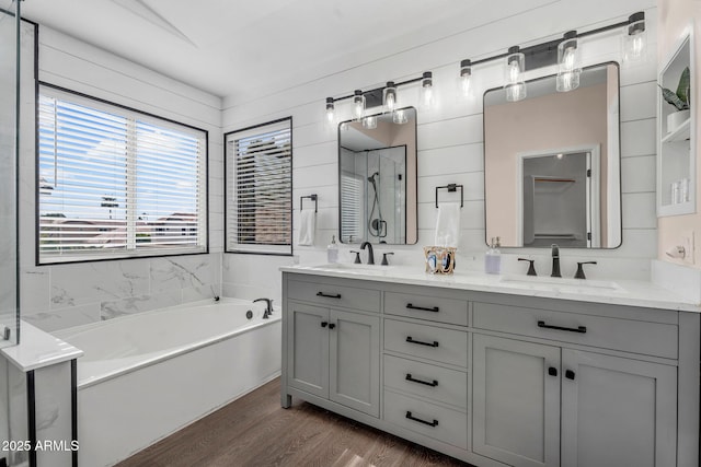 1574 E Scott Ave, Gilbert, AZ 85234 - bathroom featuring a garden tub, double vanity, wood finished floors, and a stall shower