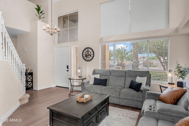 1574 E Scott Ave, Gilbert, AZ 85234 - living area featuring a chandelier, a high ceiling, plenty of natural light, light wood-type flooring, and stairway