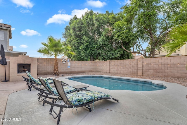 1574 E Scott Ave, Gilbert, AZ 85234 - view of swimming pool featuring exterior fireplace, a patio area, and a fenced backyard
