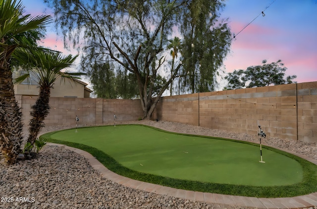 1574 E Scott Ave, Gilbert, AZ 85234 - yard at dusk featuring a putting area and a fenced backyard
