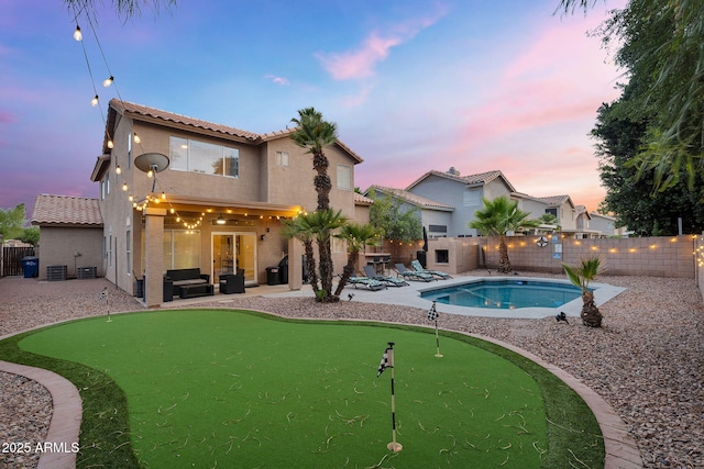 1574 E Scott Ave, Gilbert, AZ 85234 - pool at dusk with an area to practice putting, a patio, an outdoor hangout area, and a fenced backyard