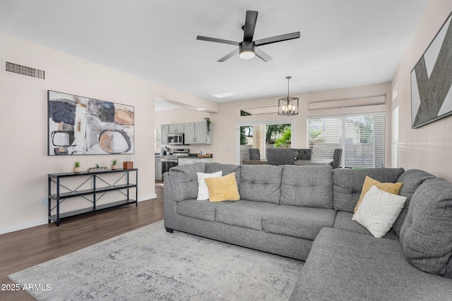 1574 E Scott Ave, Gilbert, AZ 85234 - living room with dark wood-style floors, ceiling fan, and a chandelier