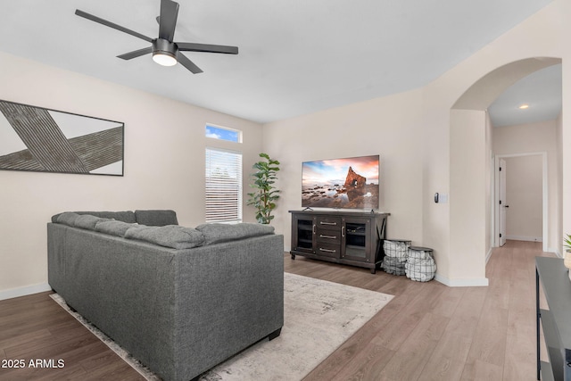 1574 E Scott Ave, Gilbert, AZ 85234 - living room featuring arched walkways, wood finished floors, and a ceiling fan