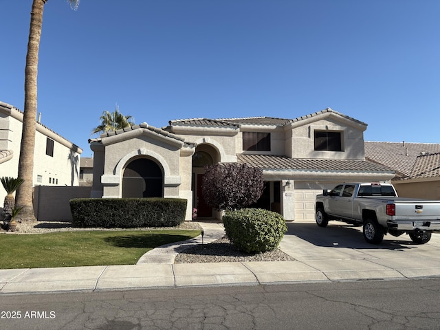 mediterranean / spanish-style home with a garage