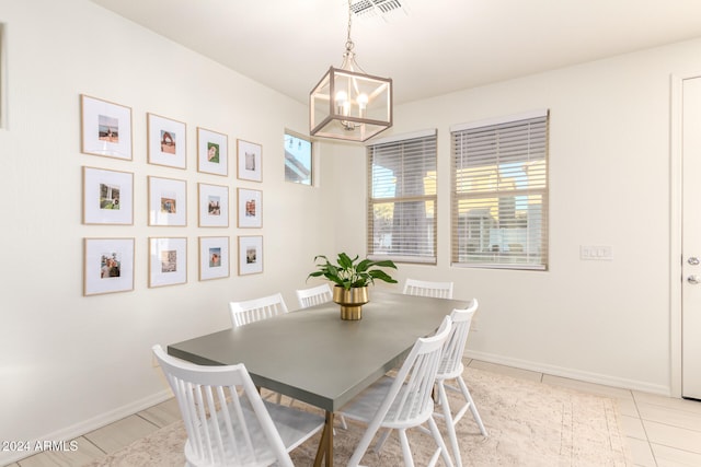 dining room featuring a chandelier and light tile patterned floors