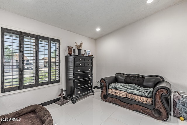 4020 W Anderson Dr, Glendale, AZ 85308 - living area featuring a textured ceiling, recessed lighting, tile patterned flooring, and baseboards