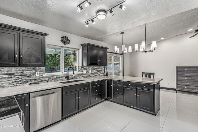 4020 W Anderson Dr, Glendale, AZ 85308 - kitchen featuring stainless steel appliances, a sink, dark cabinets, tasteful backsplash, and a peninsula