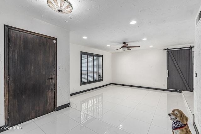 4020 W Anderson Dr, Glendale, AZ 85308 - entryway featuring a barn door, recessed lighting, ceiling fan, and baseboards