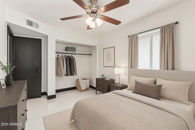 4020 W Anderson Dr, Glendale, AZ 85308 - bedroom with a closet, ceiling fan, light tile patterned floors, and baseboards
