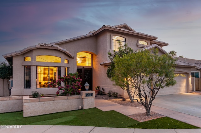 mediterranean / spanish home featuring a garage