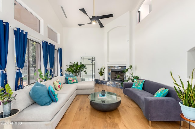 living room with high vaulted ceiling, light wood-type flooring, and ceiling fan