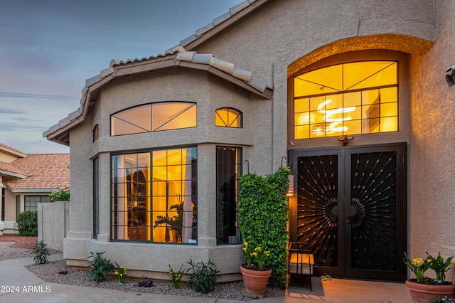 view of exterior entry at dusk