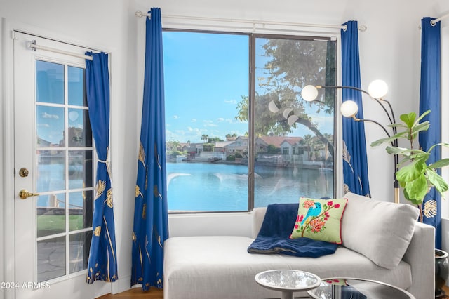 bedroom featuring a water view and hardwood / wood-style floors