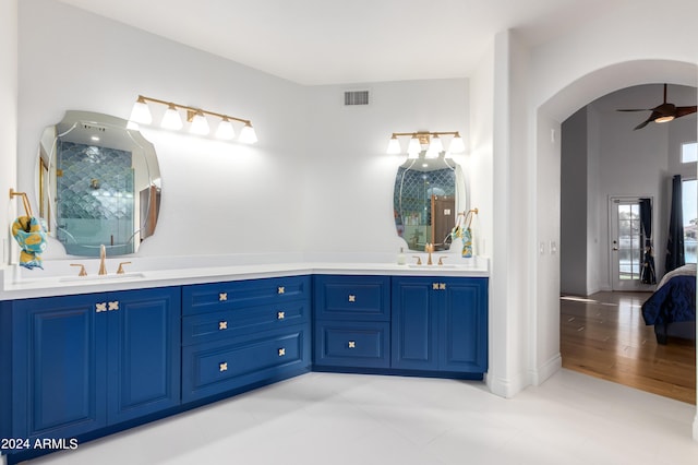 bathroom featuring double sink, tile floors, and vanity with extensive cabinet space