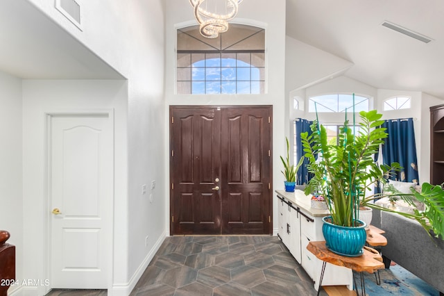 tiled entryway featuring vaulted ceiling